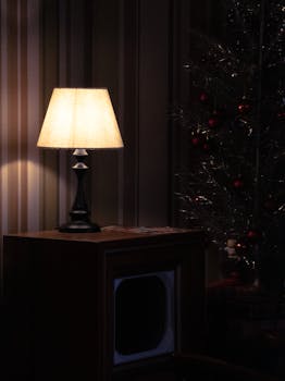Warm and cozy interior with a glowing lamp and Christmas decorations, creating a peaceful holiday ambiance.