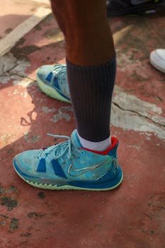 Close-up of colorful basketball sneakers on an outdoor court.