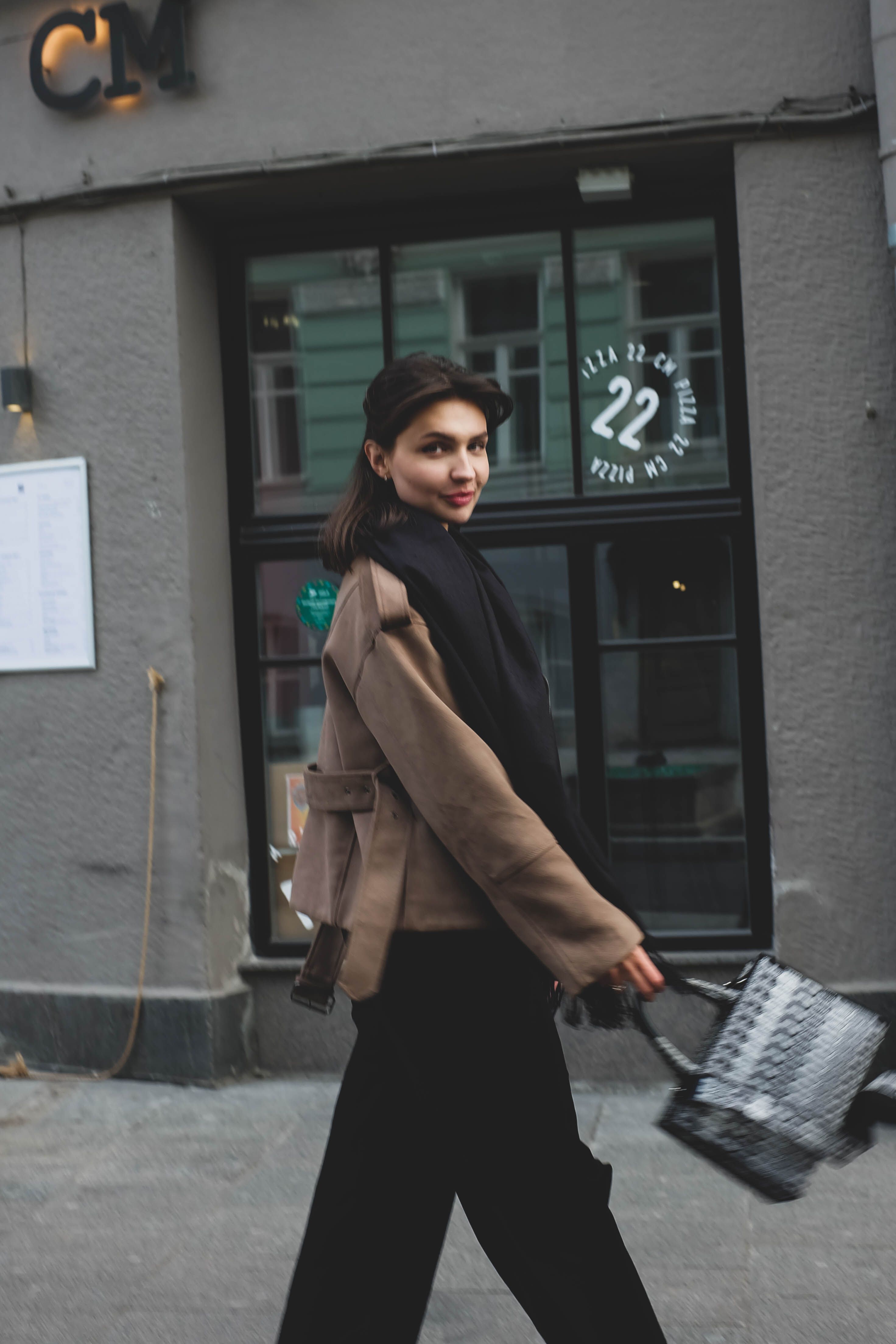 Stylish Woman Walking in Urban Setting · Free Stock Photo