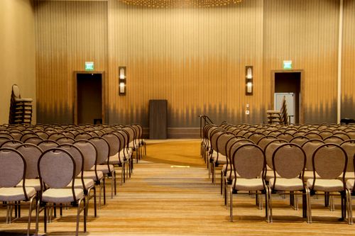 Free Spacious empty conference room with neatly arranged chairs ready for an event. Stock Photo