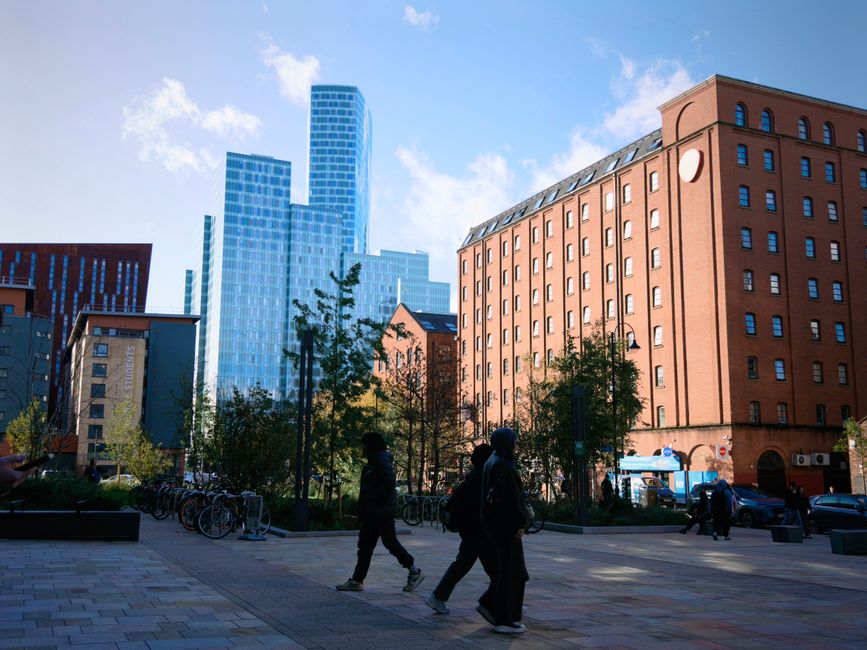 Cityscape featuring contemporary skyscrapers and pedestrians in an urban setting.