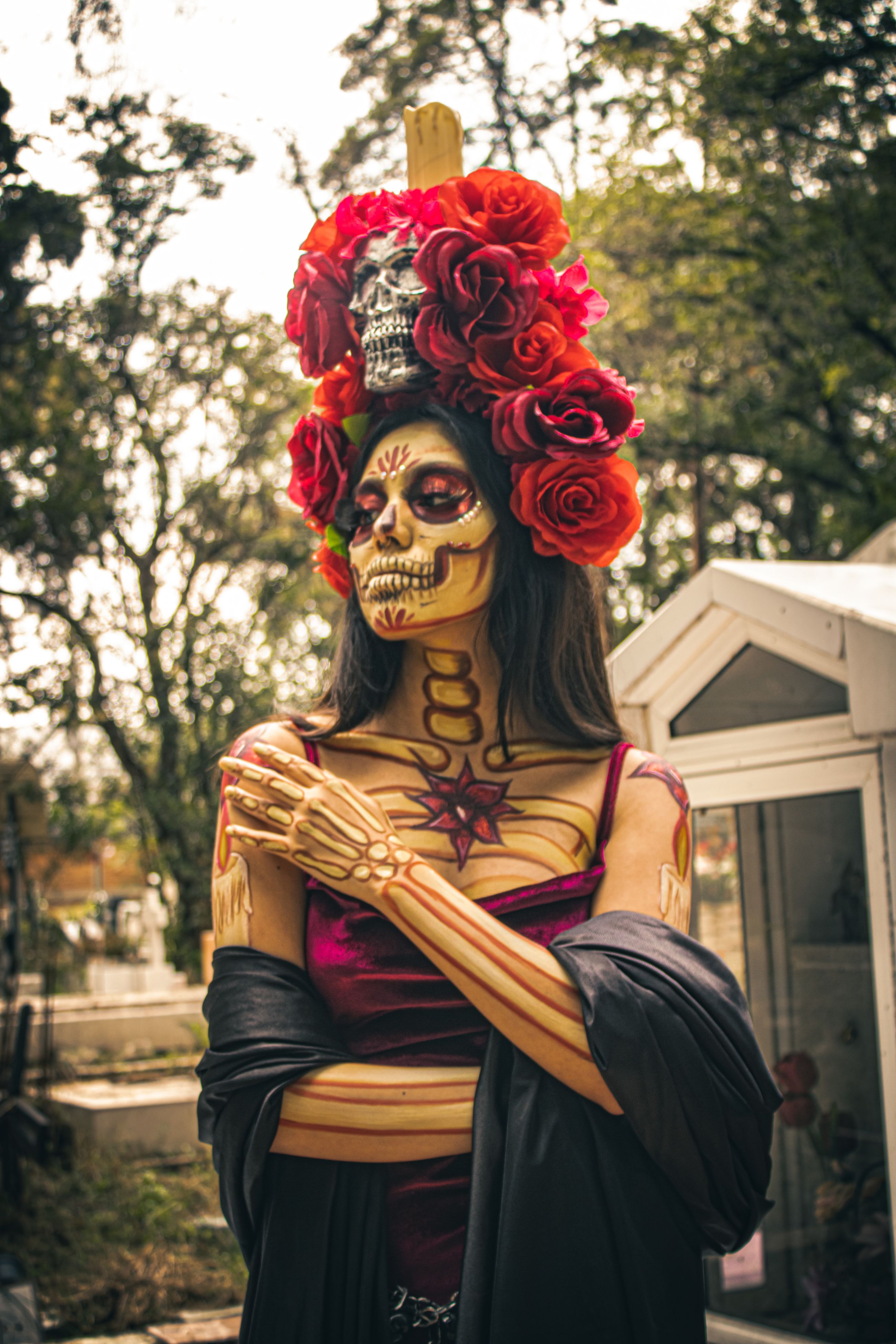 Catrina in traditional costume with a floral headdress during Día de Muertos in Mexico