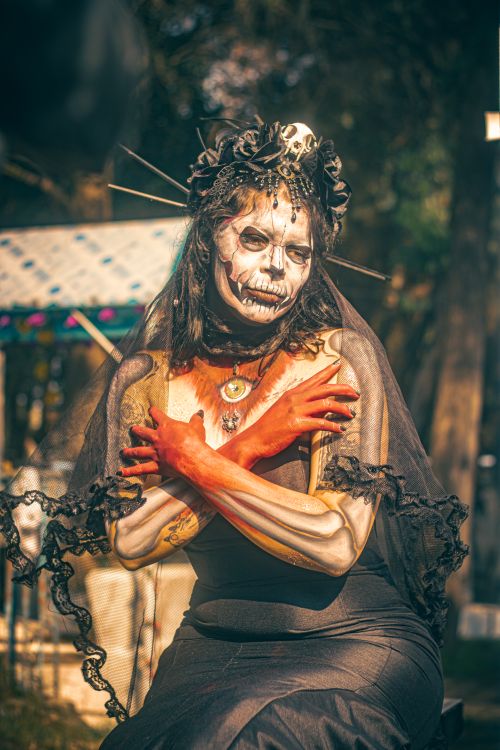 Free Artistic Catrina figure with vibrant makeup and headdress during Día de Muertos in Mexico City. Stock Photo