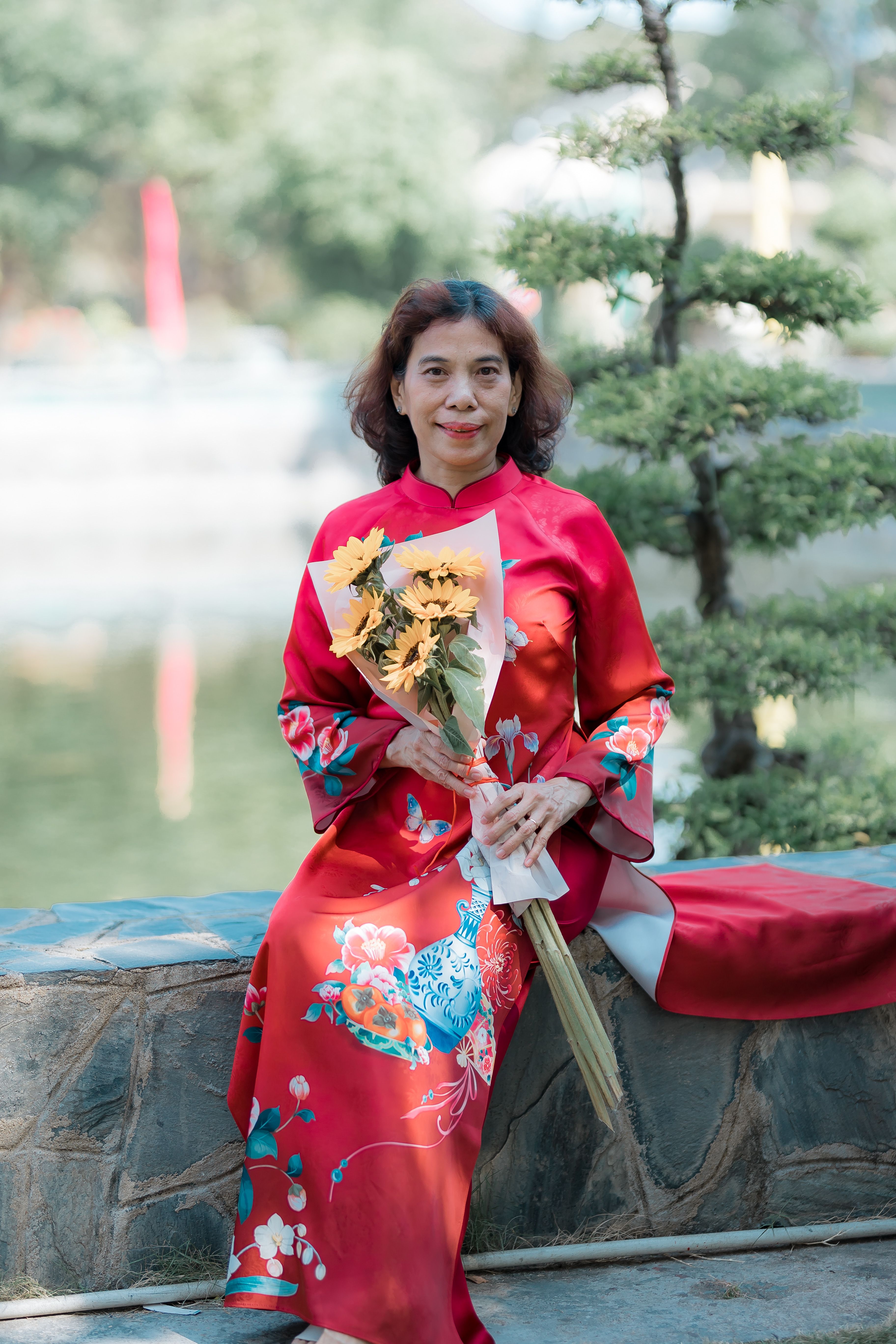 Elegant Woman in Traditional Dress with Flowers · Free Stock Photo