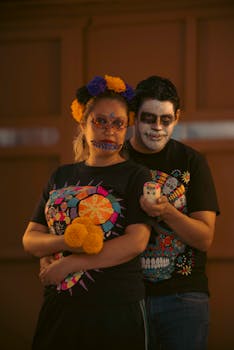 A couple with face paint and vibrant costumes embracing the spirit of Dia de los Muertos.