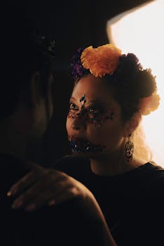 Portrait of a Day of the Dead celebration with traditional face paint and floral headdress in warm lighting.
