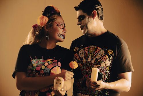 Free Couple celebrating Day of the Dead with colorful face paint and traditional attire. Stock Photo