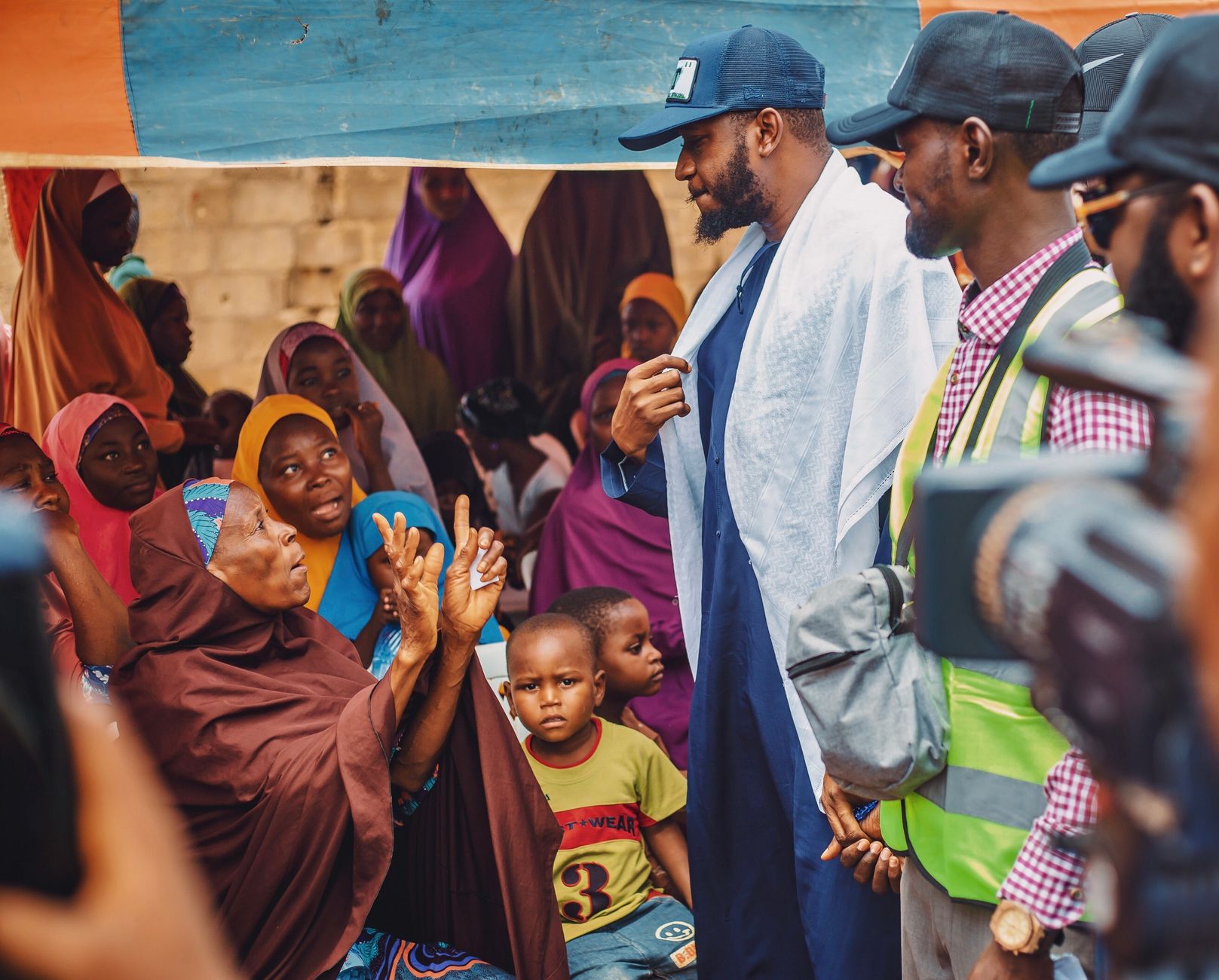 Vibrant outdoor Nigerian community gathering in Kaduna showcasing local engagement.