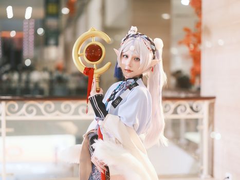 A captivating cosplay featuring an enchanting character with ornate costume and mystical staff.