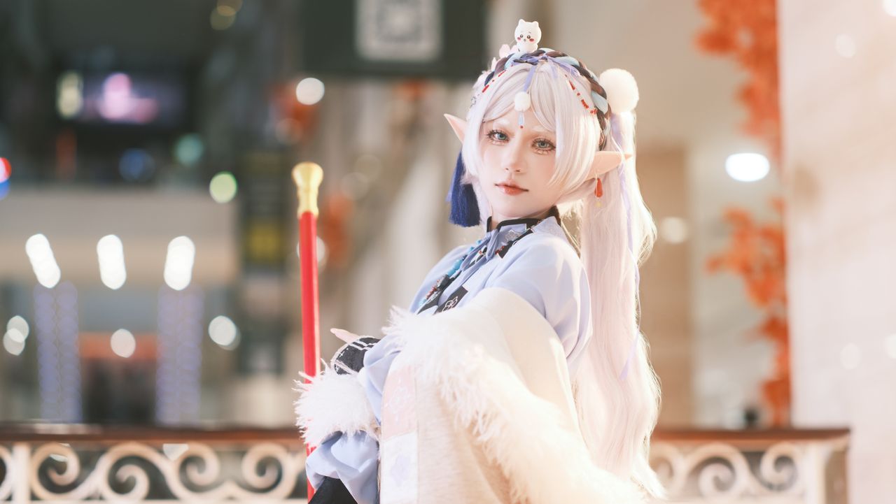 cosplayer dressed as a fantasy elf indoors featuring detailed costume