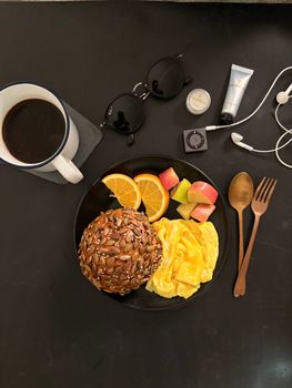 A savory breakfast scene with scrambled eggs, fruit, and coffee, perfect for a morning start.