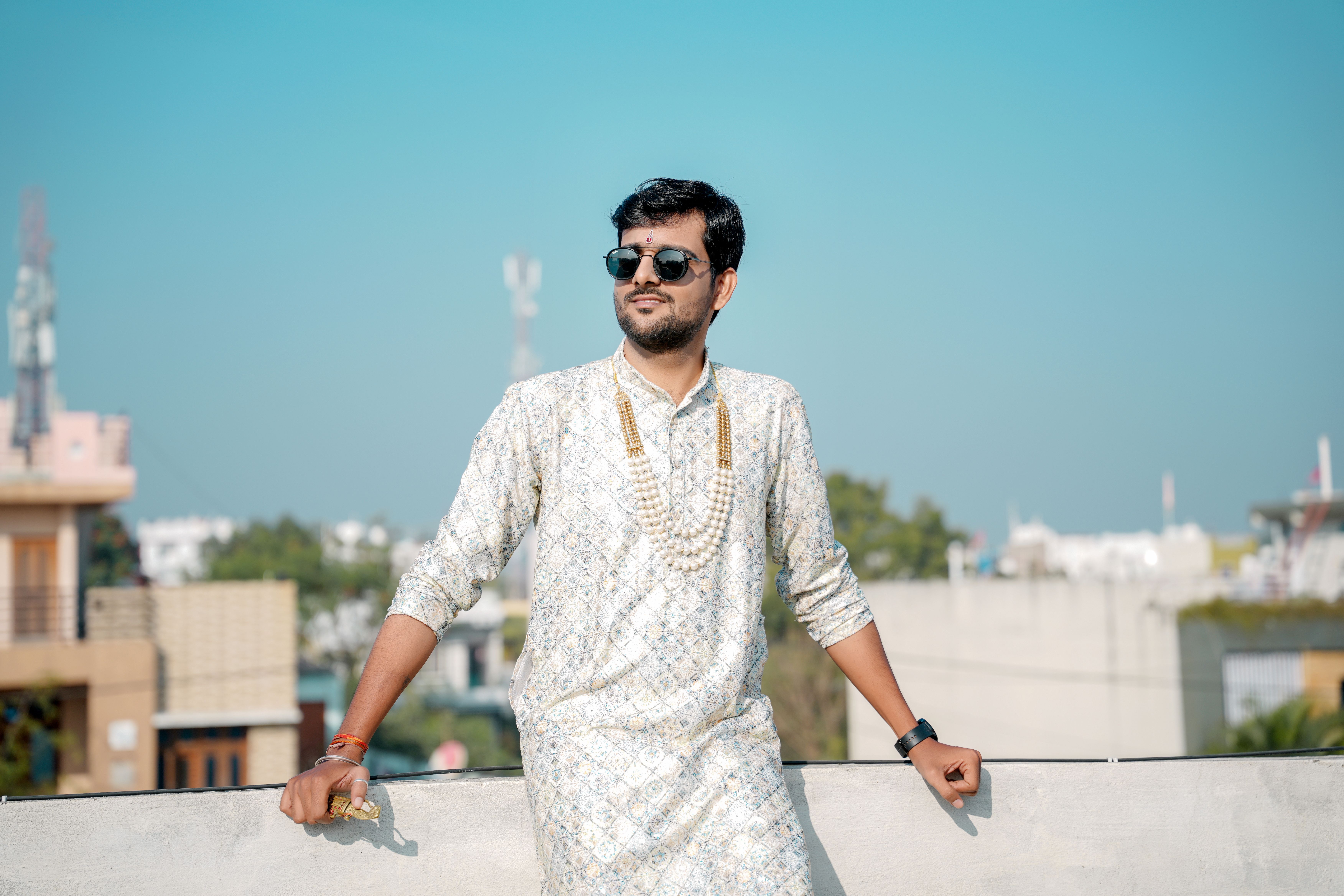 Young man in traditional attire on a rooftop · Free Stock Photo