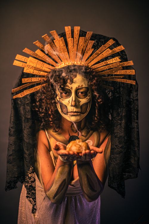 Free Artistic portrait of a Catrina figure for Día de Muertos with skull makeup and ornate headdress. Stock Photo