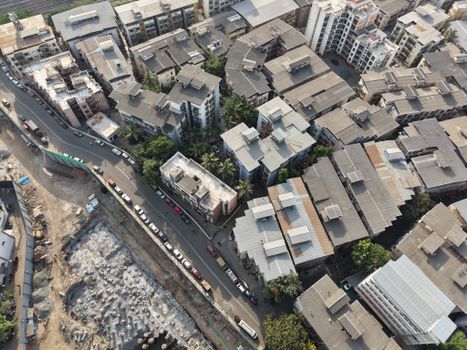 Aerial shot of residential buildings and street in Mumbai, India on a sunny day.