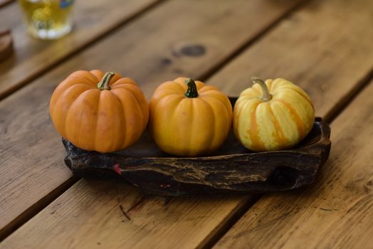 Small autumn pumpkins on a rustic wooden table