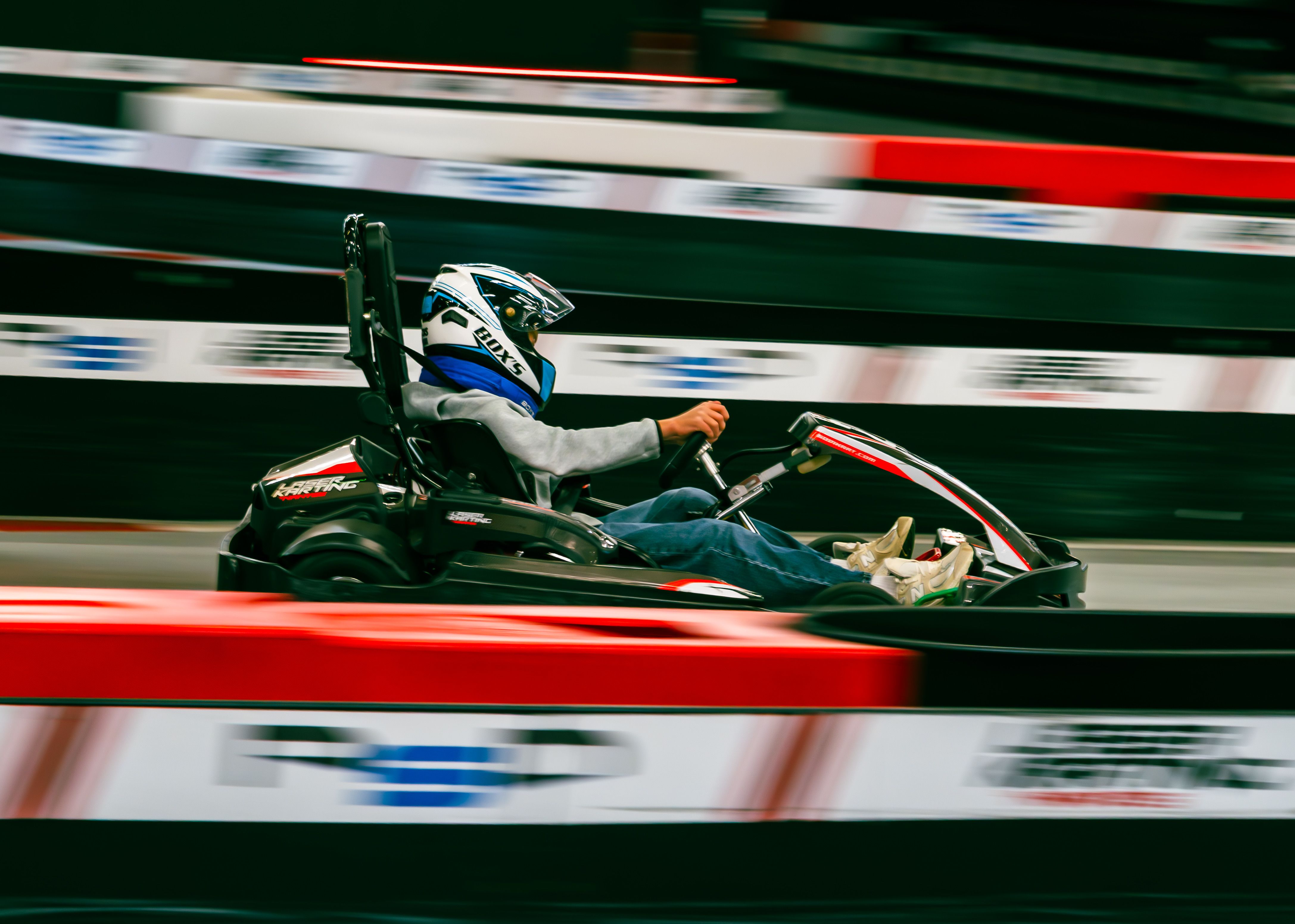 Exciting Indoor Go-Kart Racing Action · Free Stock Photo