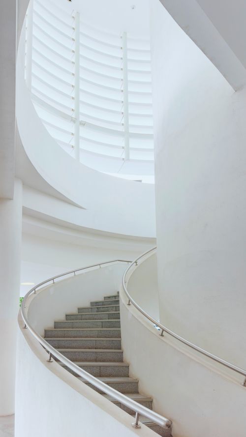 Free Minimalistic white spiral staircase in a modern Malaysian building, captured in daylight. Stock Photo