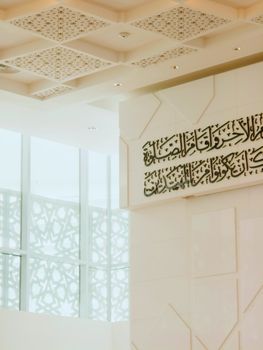 Elegant interior design of a mosque in Malaysia showcasing Islamic calligraphy and motifs.