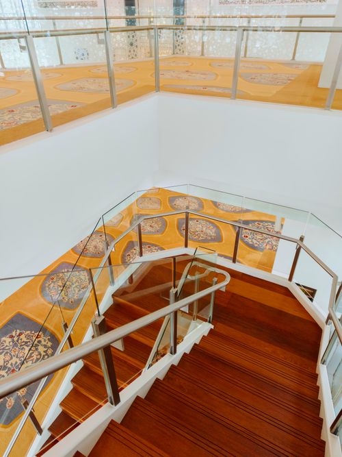Free A modern spiral staircase within a beautifully designed mosque in Malaysia, featuring intricate carpets. Stock Photo