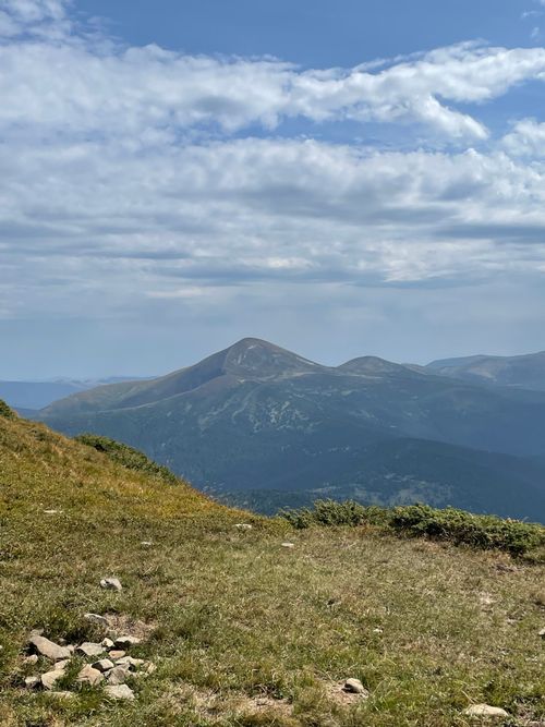 Free A tranquil view of mountains under a partly cloudy blue sky. Stock Photo