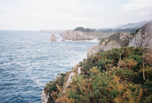 Scenic view of rugged cliffs and vast ocean in Ribadesella, Spain. Perfect for travel enthusiasts.