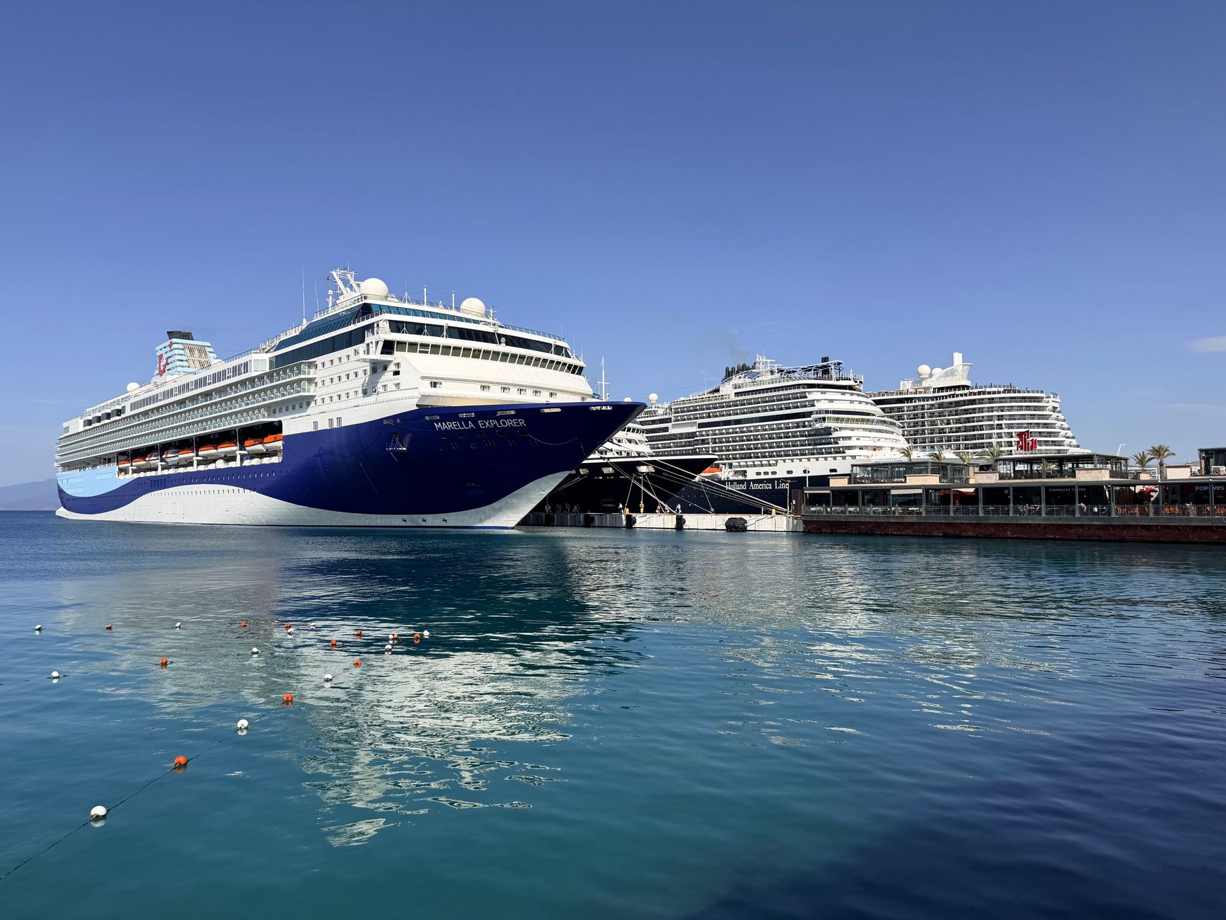 Elegant cruise ships at Kusadasi port on a bright day, perfect for a cruise-and-resort Mediterranean plan