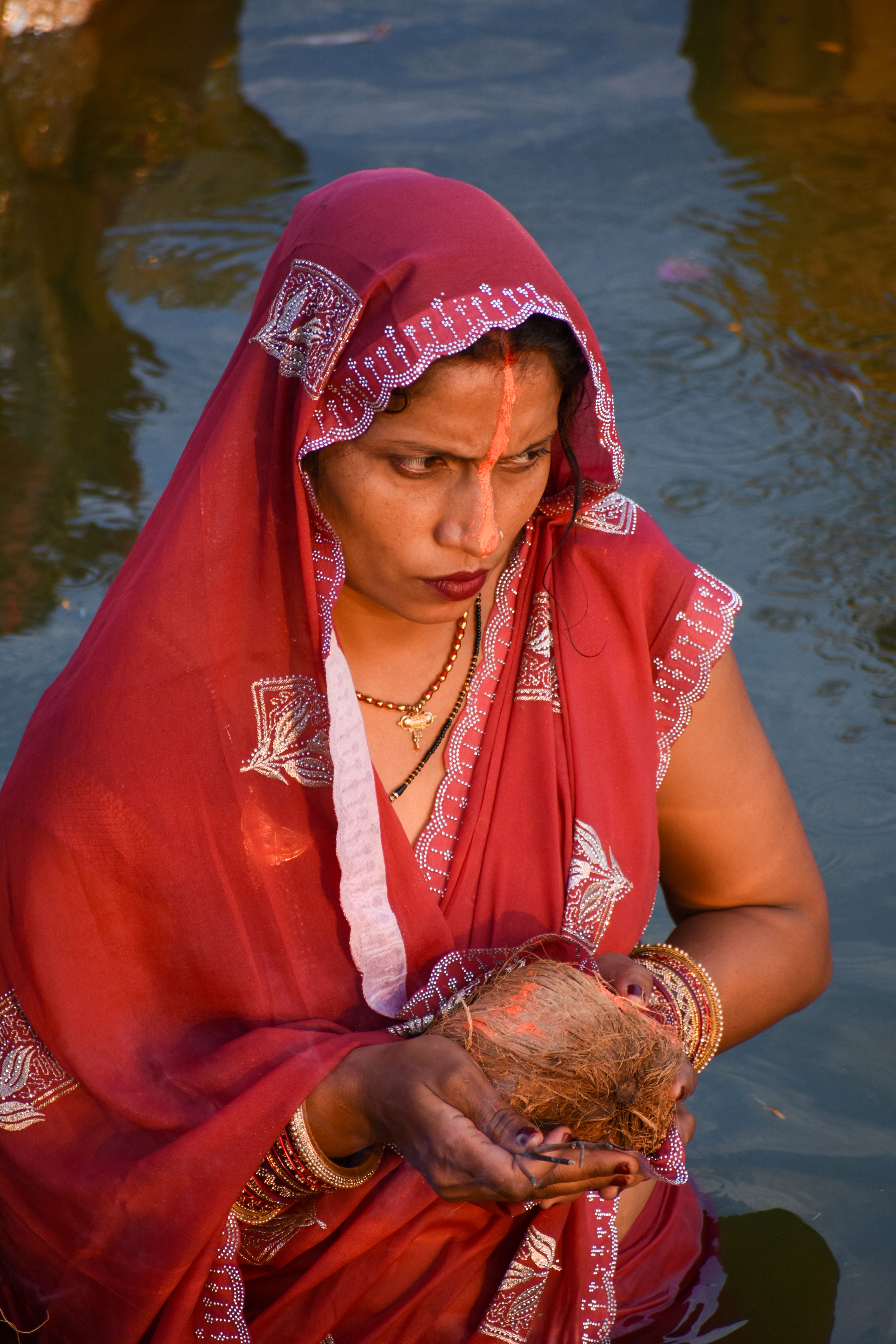 Woman performing traditional ritual in river · Free Stock Photo
