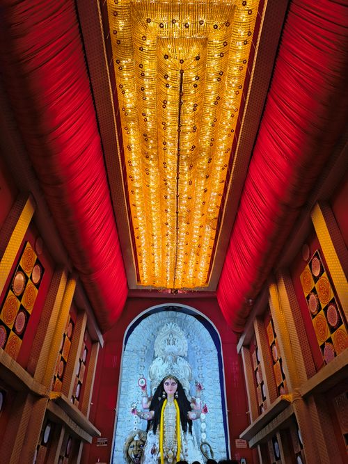 Free Glimpse into a vivid Hindu temple with an ornate Durga idol, vibrant decor, and intricate artwork. Stock Photo