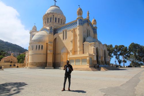 Free Man standing outside the Basilica of Notre Dame d'Afrique in Algiers. Stock Photo