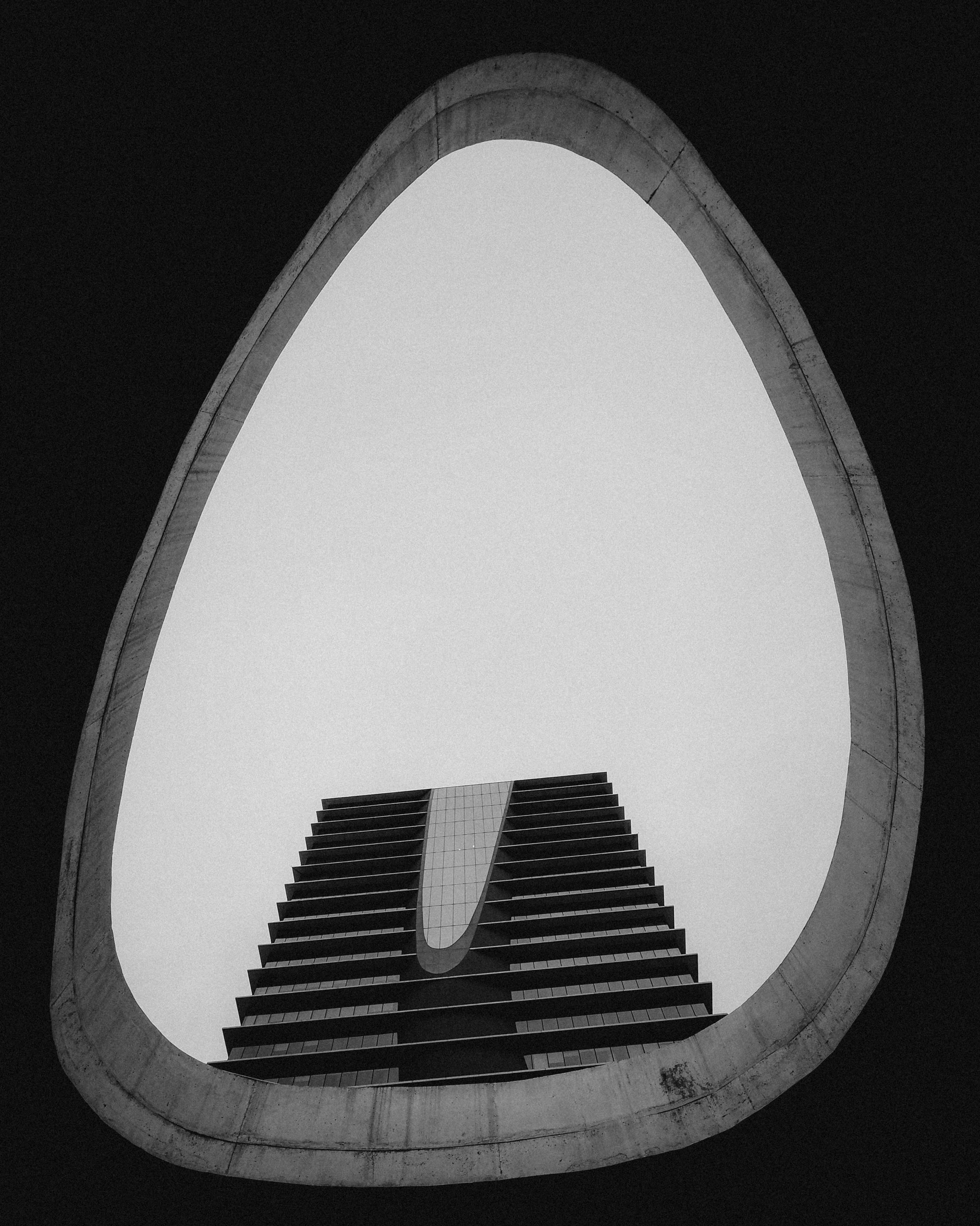 Abstract view of modern architecture through a circular frame in monochrome.