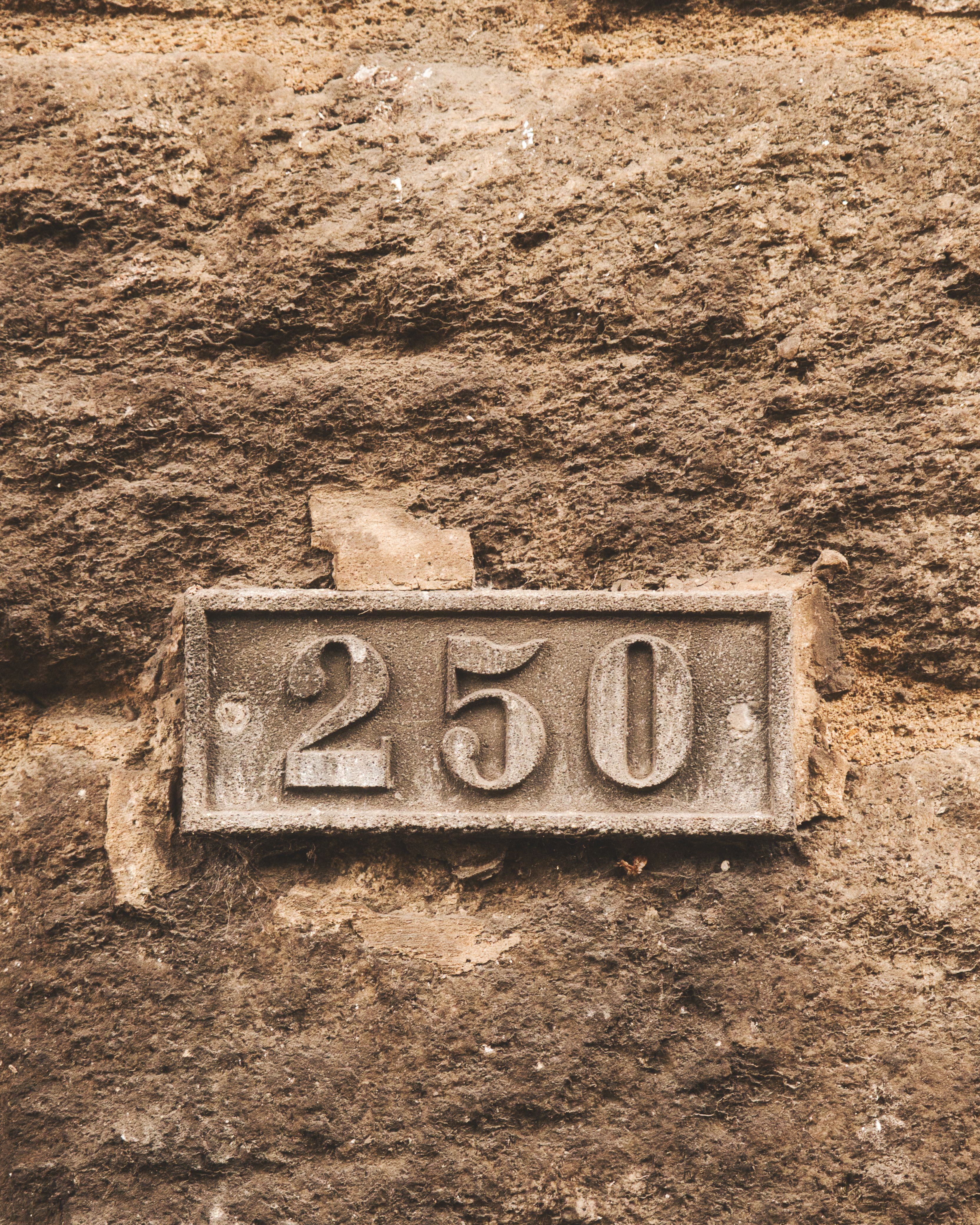 Rustic House Number 250 on Stone Wall · Free Stock Photo