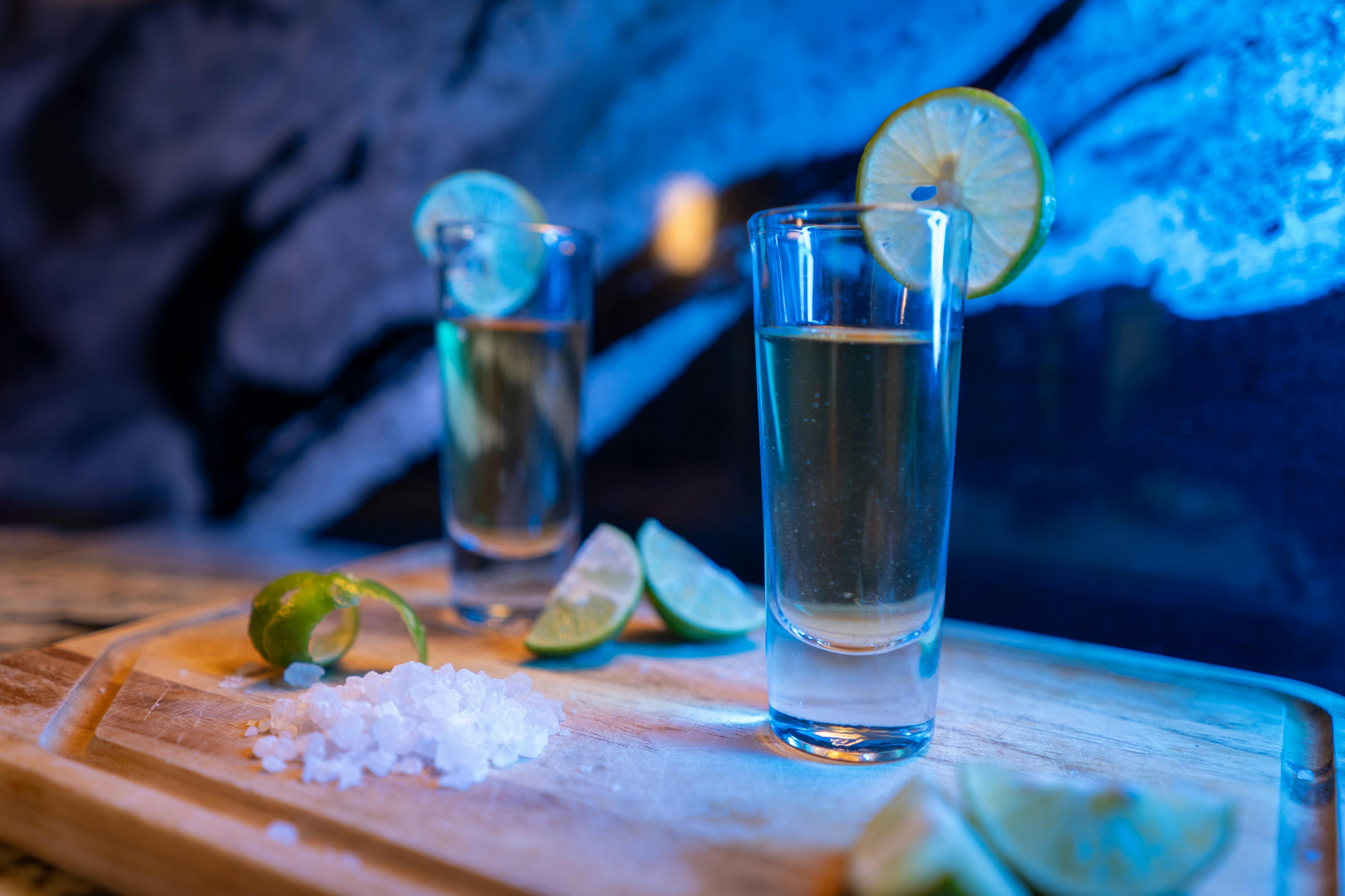 Vibrant bar scene with tequila shots, lime slices, and salt ready for a lively night.