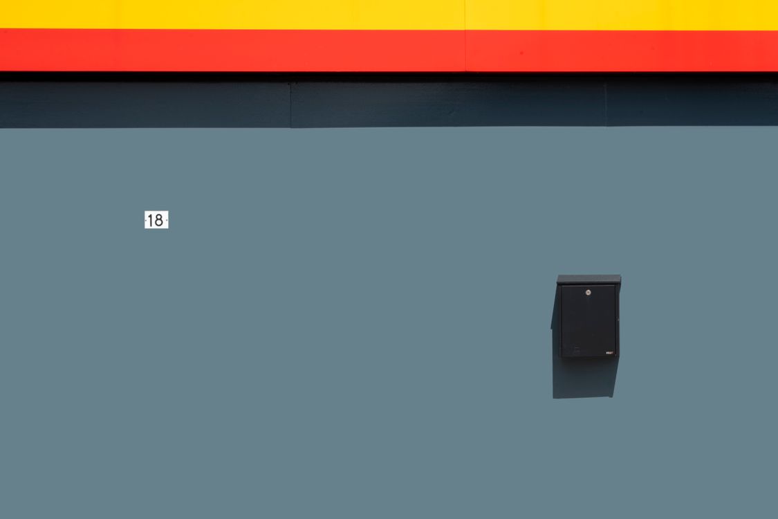 Minimalist Wall Design with Mailbox and Number 18 · Free Stock Photo