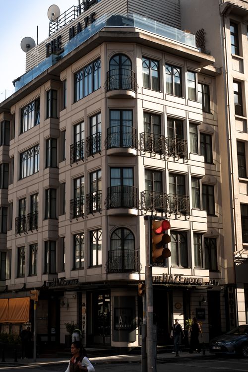 Free Elegant urban corner building illuminated by sunset light, showcasing classic architectural design in a bustling city. Stock Photo