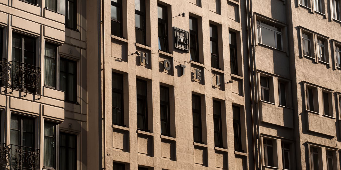Sunlit facade of an urban hotel building showing classic architecture