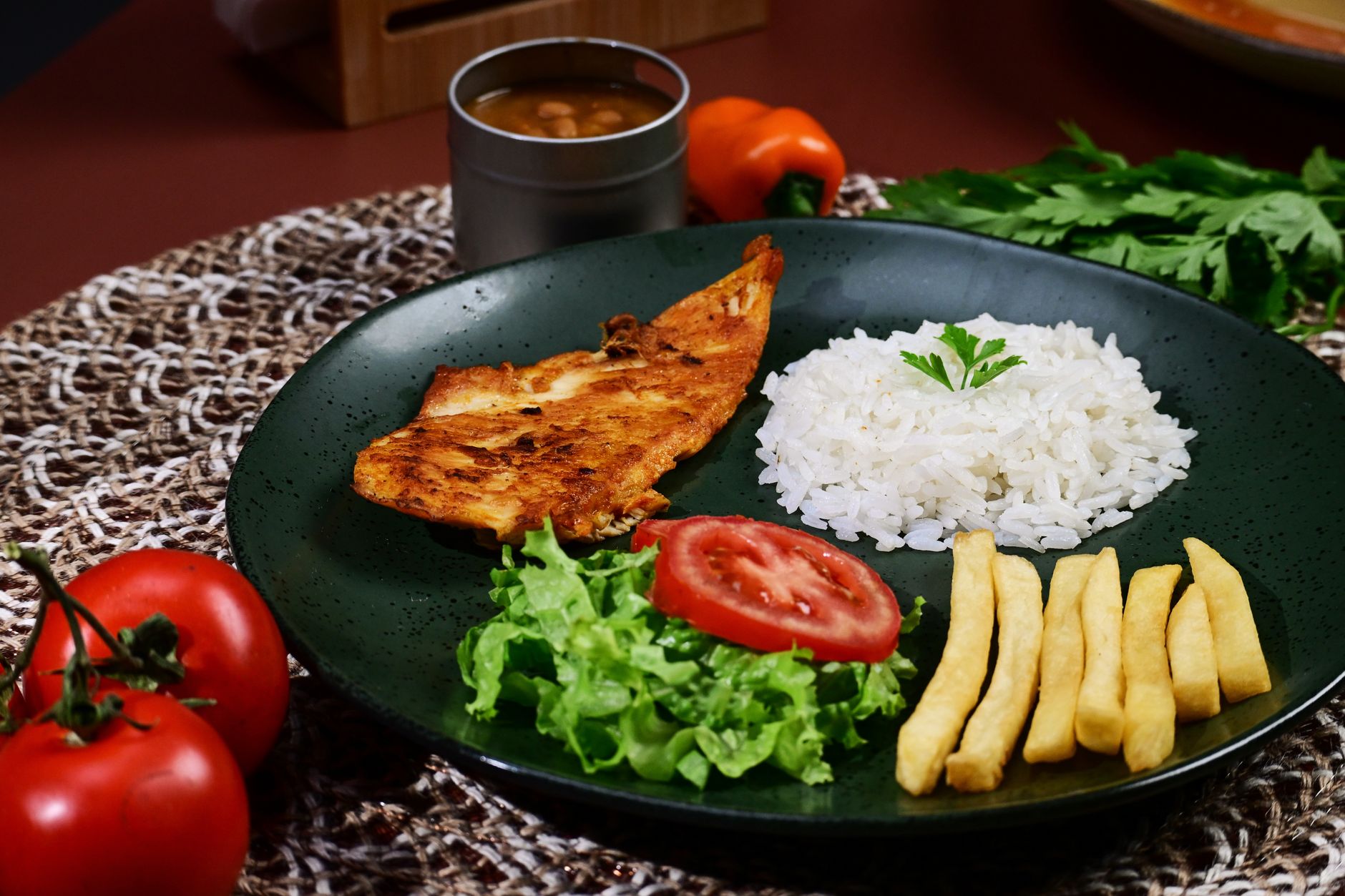 Bowl of baked chicken breast served over fluffy rice garnished with herbs