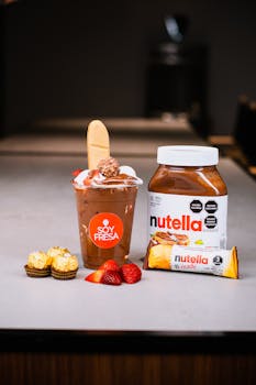 Indulge in a rich Nutella dessert garnished with strawberries and Ferrero Rocher chocolates.