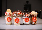 Savor a variety of delicious dessert cups from Soy Fresa, featuring fresh strawberries and toppings.