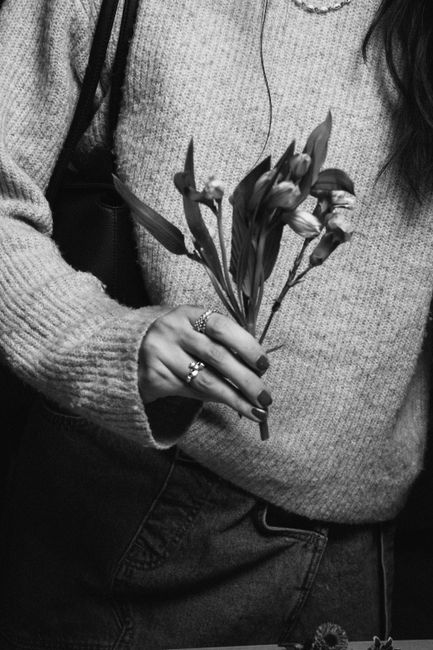 Black and white image of a person holding flowers in Charlotte, NC