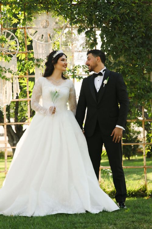 Free Bride and groom smiling at each other during outdoor wedding ceremony. Stock Photo