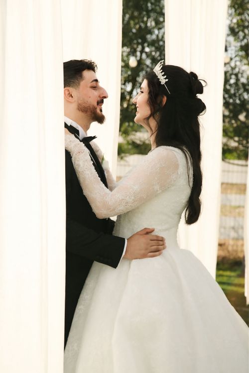 Free Bride and groom embracing outdoors on sunny day. Stock Photo