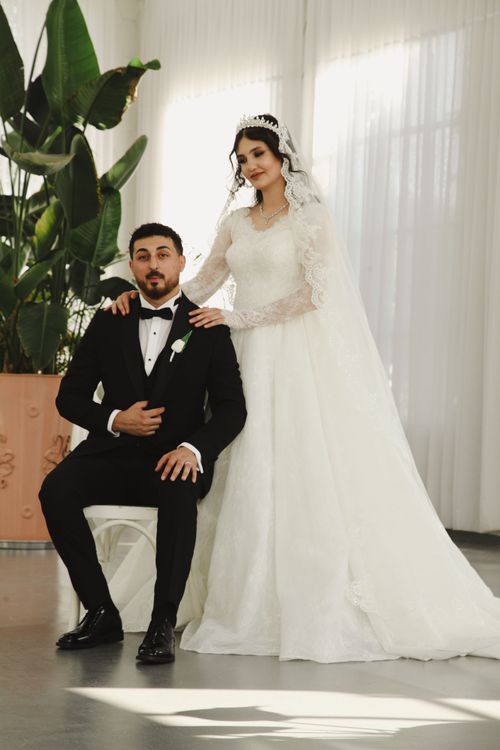 Free Beautiful indoor wedding portrait with bride and groom in natural light. Stock Photo