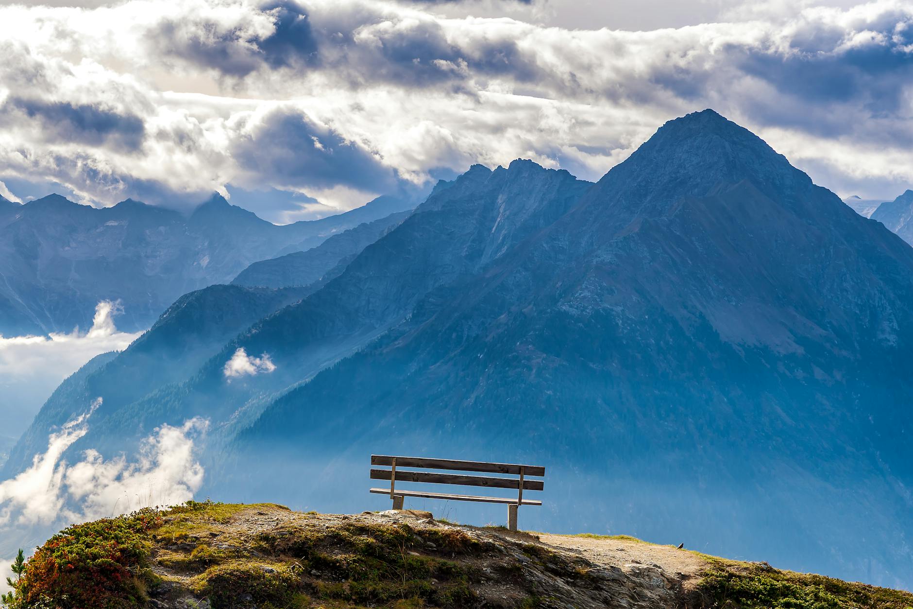 Breathtaking view of the Alps from a scenic bench in Finkenberg, Austria.