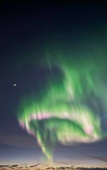 Stunning view of the Northern Lights illuminating the night sky with vibrant colors in Iceland.