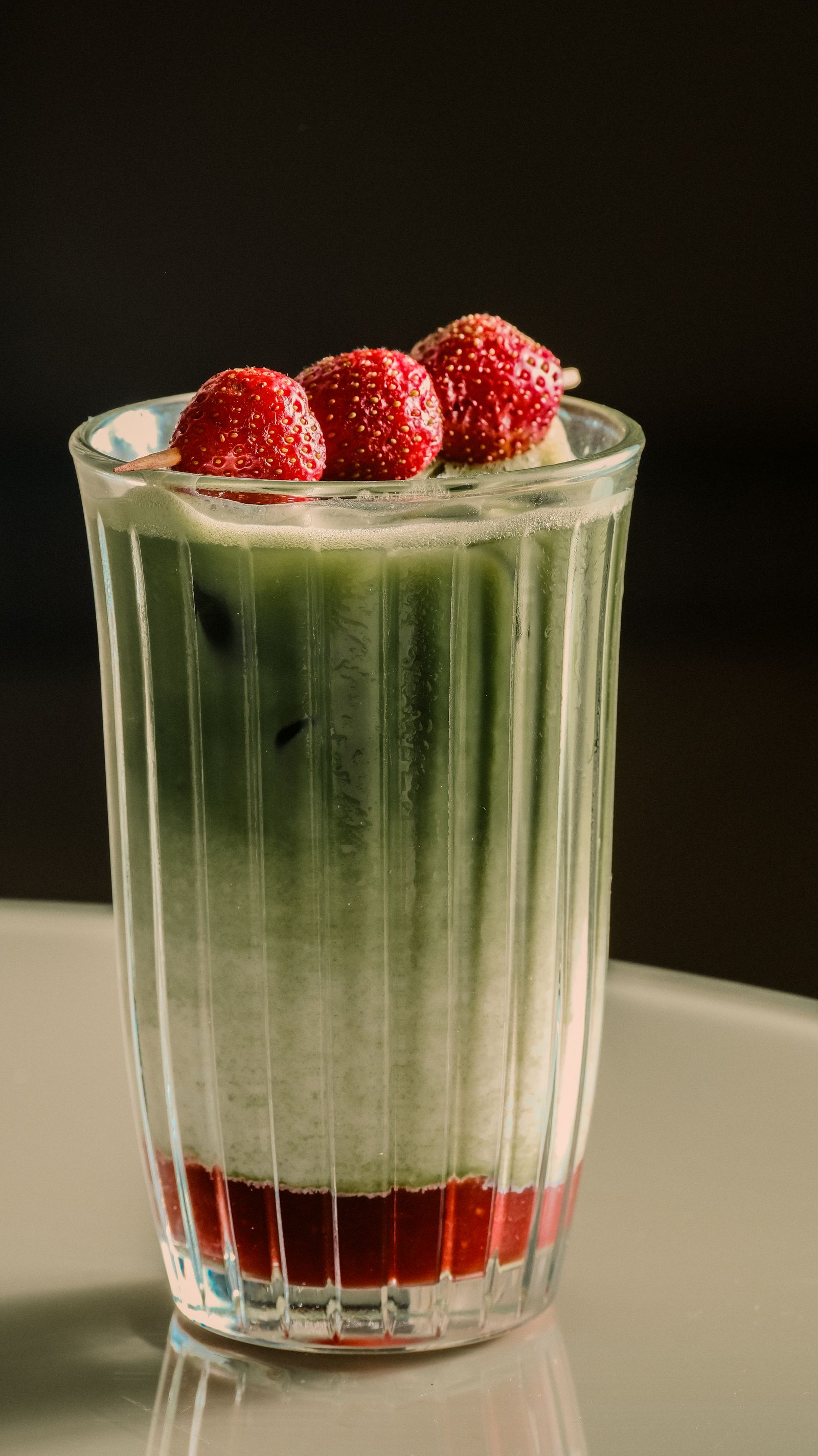 Matcha latte styled on a sunny cafe table with pastry