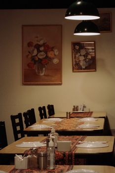 Charming indoor restaurant setting featuring floral art, inviting ambiance, and neatly set tables.