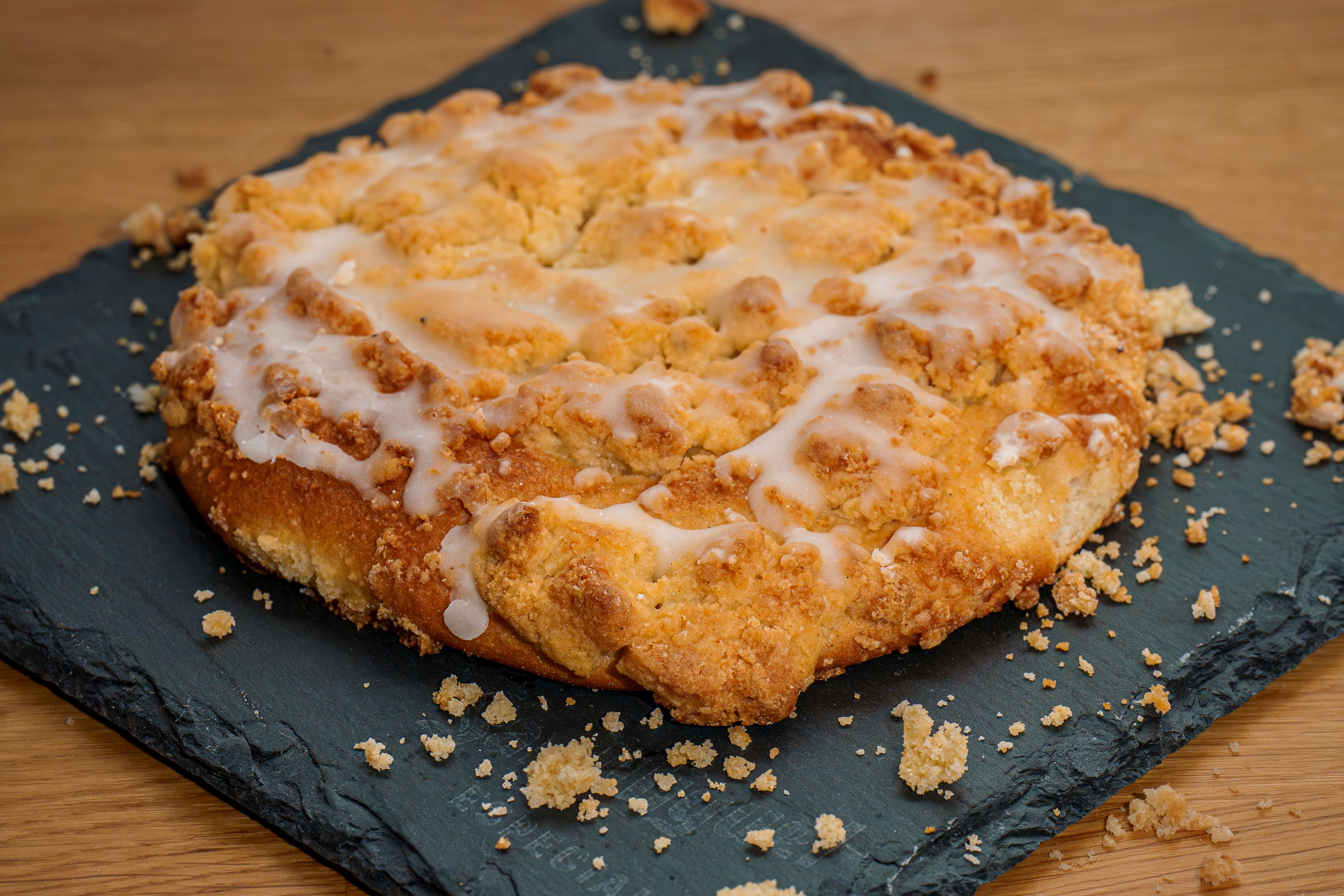 Close-up of a freshly baked crumb cake with a sugar glaze, perfect for dessert enthusiasts.