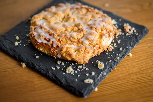 Free Delicious iced coffee cake with crumble topping on a slate board. Stock Photo