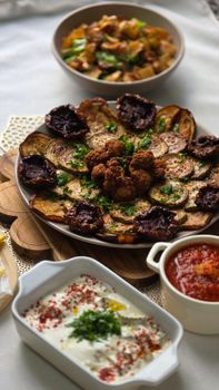 A vibrant Middle Eastern mezze platter with fresh dips and grilled vegetables for a cultural dining experience.