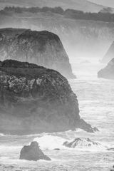 Rugged coastline in mist, photo by Griffin Wooldridge on Pexels